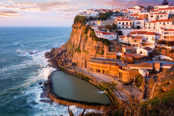 a large body of water with a city in the background