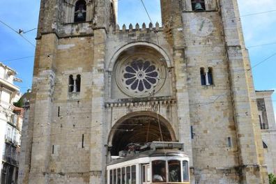 a bus driving down a street in front of a building