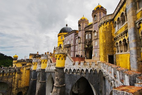 a group of people standing in front of a castle