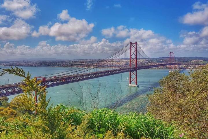 a train crossing a bridge over a body of water