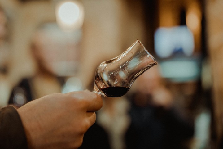 a person holding a wine glass