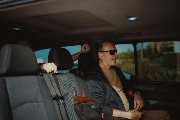a man sitting on the seat of a car