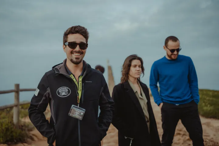 a group of people standing together smiling for the camera