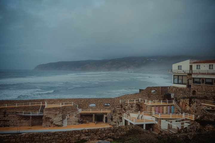 a wooden bench sitting next to a body of water