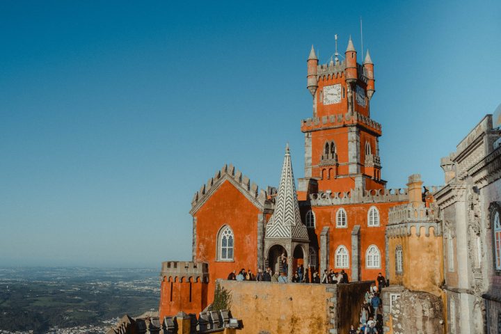 a castle with a clock at the top of a building