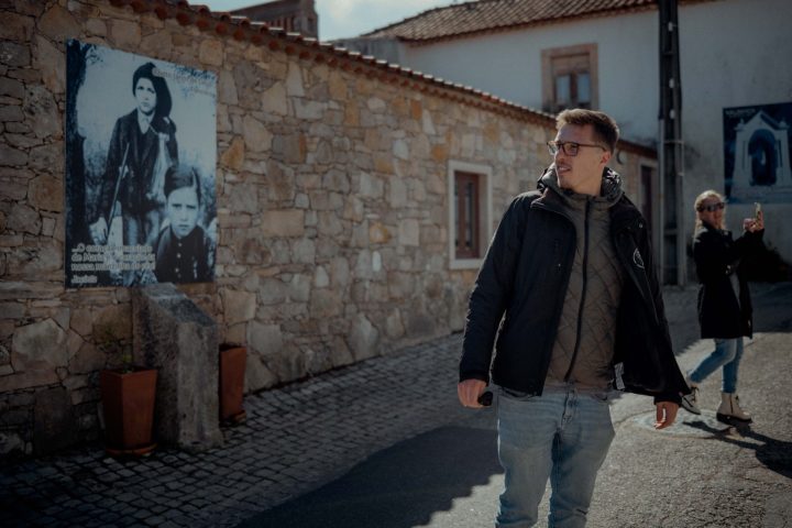 a person standing in front of a brick building