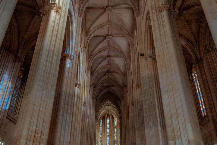 a large wooden bench in front of a building