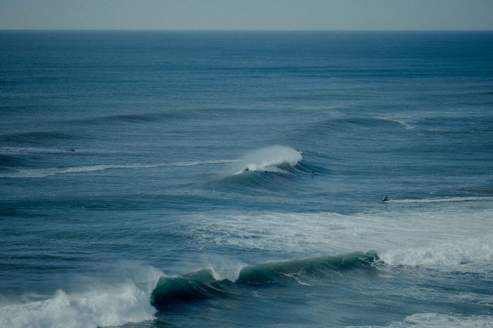 a man riding a wave on top of a body of water