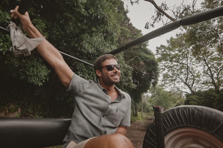 a man standing in front of a car