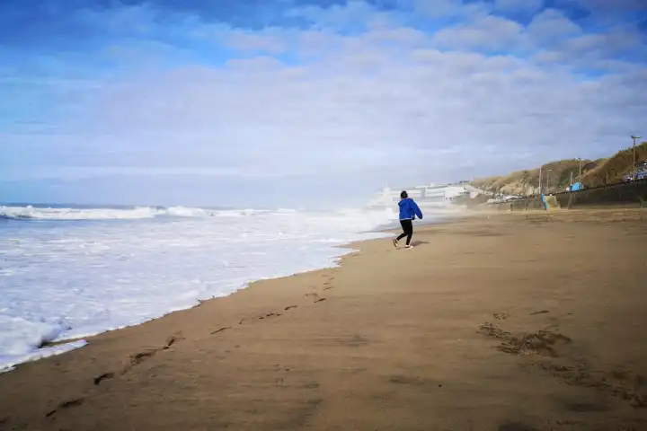 a man riding on top of a sandy beach