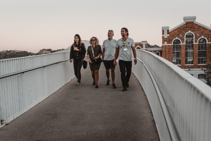 a man and a woman walking on a bridge