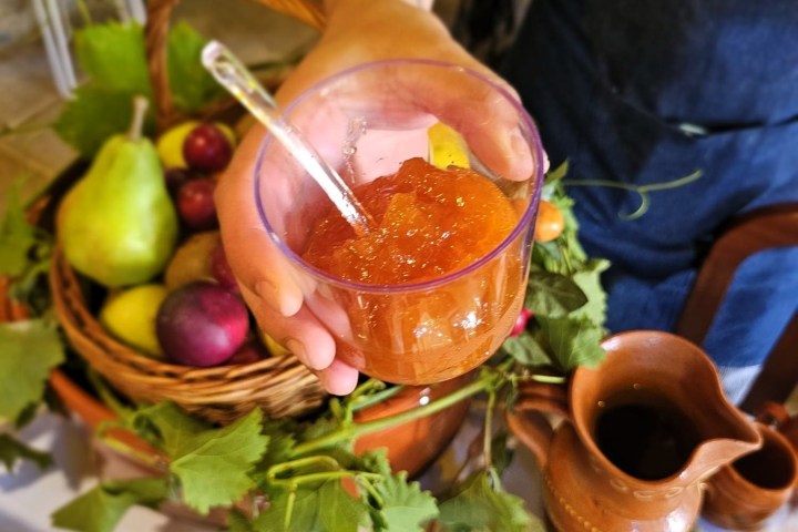 a person sitting at a table with a plate of food