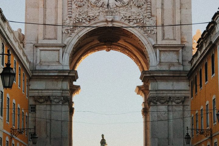 a group of people walking down a street next to a building