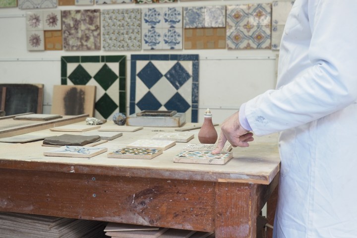 a person standing on top of a cutting board with a cake