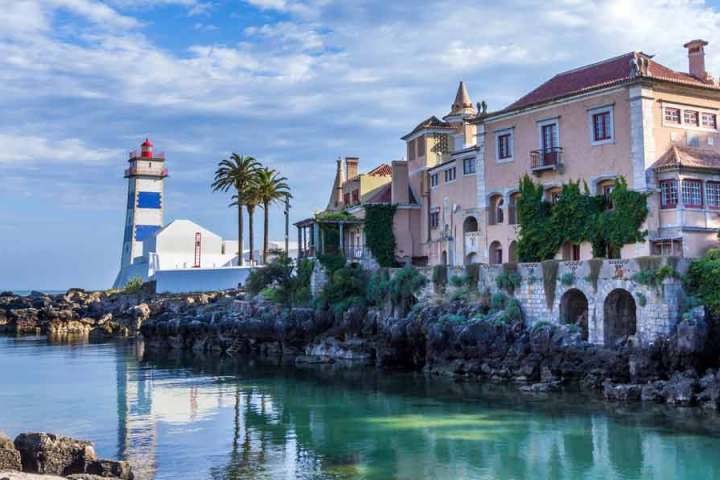 a castle with water in front of a body of water