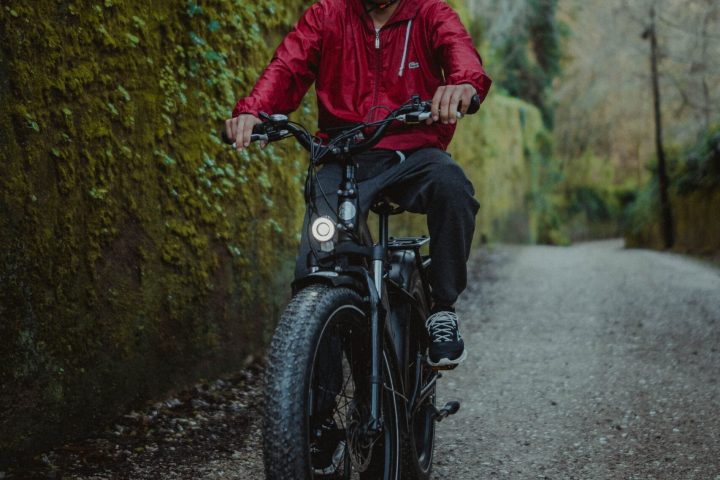 a man riding a motorcycle down a dirt road