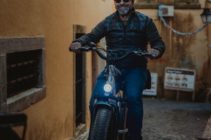 a man riding a motorcycle in front of a building