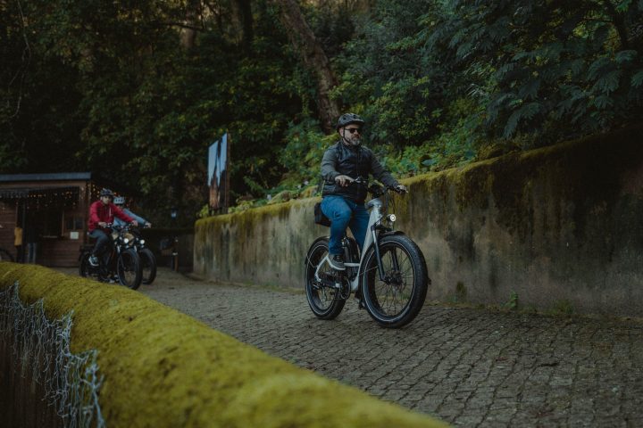 a man riding a bike down a dirt road