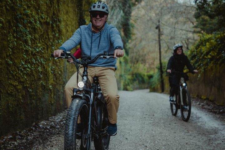 a man riding a motorcycle down a dirt road