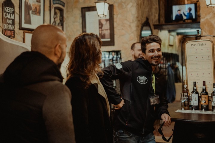 a group of people standing in front of a restaurant