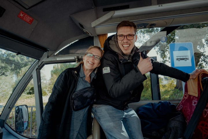 a man and a woman sitting in a car