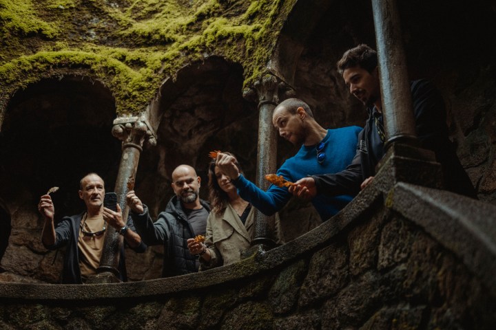 a group of people standing on a bridge