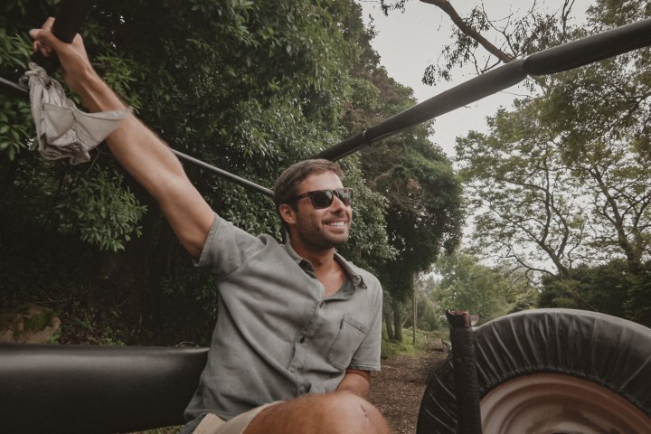 a man standing in front of a car