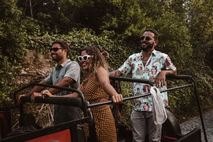 a group of people riding on the back of a truck