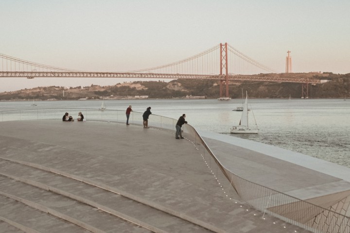 a group of people on a beach near a body of water