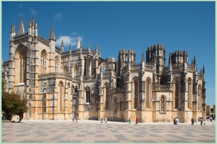 a large stone building with Batalha Monastery in the background