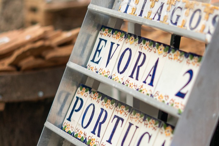 Decorative ceramic tiles on display, with 'Evora' and 'Portugal' text.